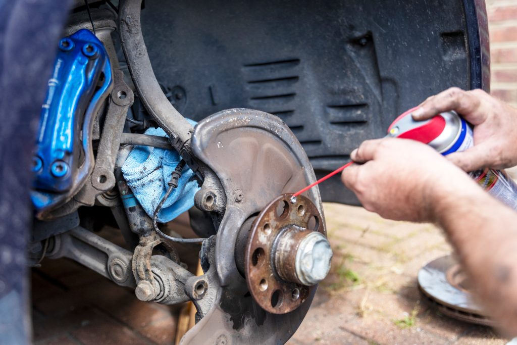 Mechanic working on a car brake hub